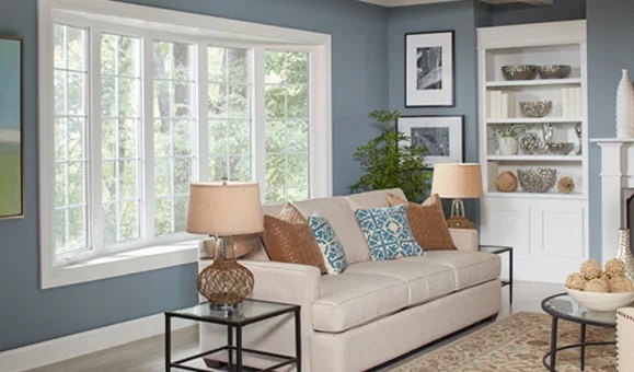 A happy homeowner Brussels enjoying a cooler home after a window seal repair improved insulation